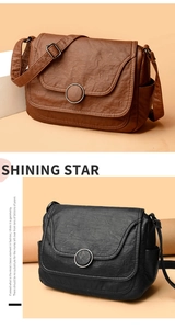 Close-up of vintage soft leather crossbody bags with round metal buckle and side pocket