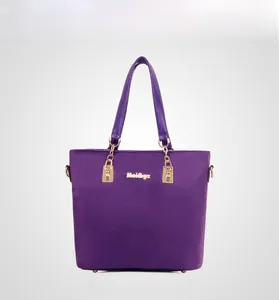 Front view of a purple nylon tote bag with golden hardware and chain detail