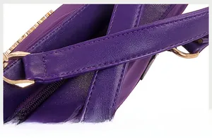 Detailed macro view of purple PU leather texture with gold metal ring and stitching