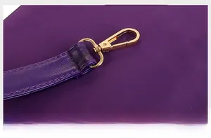 Detail of durable purple nylon fabric with gold metal hook and precision stitching