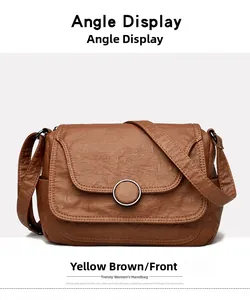 Front view of yellow-brown soft leather shoulder bag with circular metal ring detail