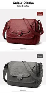 Detail view of red and grey soft leather shoulder bags with round metal buckle and texture