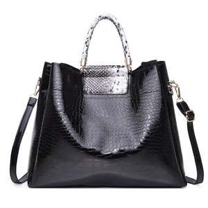 Black crocodile embossed tote bag with snake print handles and adjustable shoulder strap