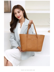 Dettaglio di una grande borsa tote gialla con motivi geometrici portata da una modella