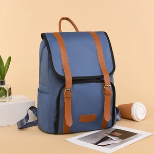 Navy blue lightweight backpack with brown leather straps and retro contrast design