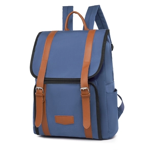 Classic blue canvas backpack with brown leather straps and buckle flap for casual style