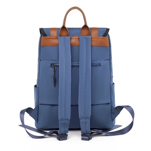 Blue nylon backpack with brown leather trim and back zipper pocket from a rear view
