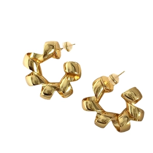 Polished gold metallic twisted ribbon hoop earrings with C-shape design on white background