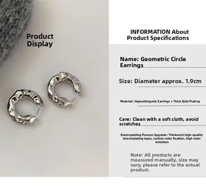 Detailed view of silver geometric hoop earrings with hammered texture and 1.9cm diameter