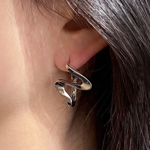 Silver wave earrings worn by a model showing the minimalist S-shaped curved design