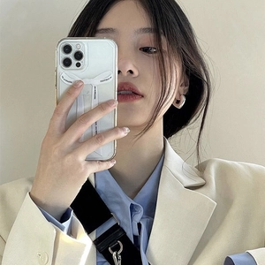 Close-up of minimalist cream white phone case with 3D ribbon bow and heart earrings