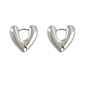 Polished silver heart-shaped chunky hoop earrings with a minimalist modern design