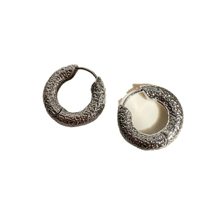 Silver hoop earrings with a unique hammered meteorite texture and secure clip closure