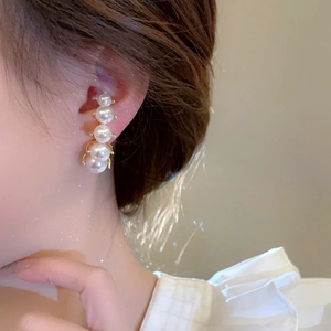 Elegant vertical drop pearl earrings featuring five white pearls on a gold-plated base