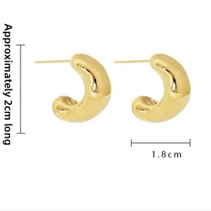 Macro view of gold chunky C-shaped hoop earrings with precise size dimensions shown