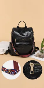 Close-up of black crocodile pattern PU leather backpack with colorful knit straps