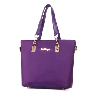 Stylish purple nylon tote bag for women featuring golden chain straps and logo details