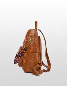 Brown crocodile pattern backpack with side pocket and colorful woven shoulder strap