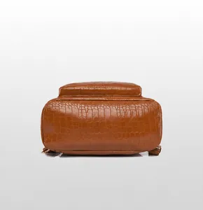 Detailed bottom view of brown anti-theft backpack with crocodile texture PU leather