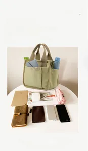 Large capacity canvas tote bag with multiple pockets showing daily essentials storage