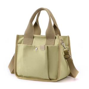 Large capacity khaki canvas handbag with multiple pockets and adjustable crossbody strap