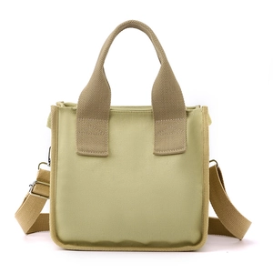 Large olive canvas tote bag with top handles and adjustable crossbody strap for women