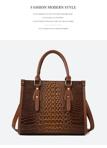 Close-up of deep brown crocodile pattern texture and golden rivets on the tote bag