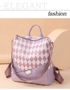 Detail of purple plaid backpack featuring classic diamond pattern and metallic logo plate