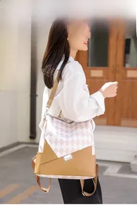 Outdoor shot of stylish colorblock backpack showing quilted texture and metal hardware details