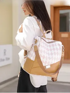 Detail view of pink diamond pattern canvas and brown leather stitching on woman backpack