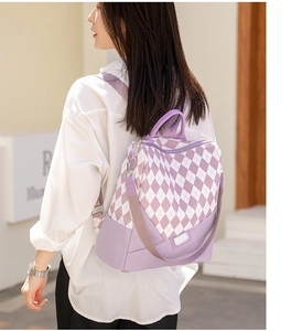 Detail of water-resistant purple diamond lattice backpack with smooth metal zippers