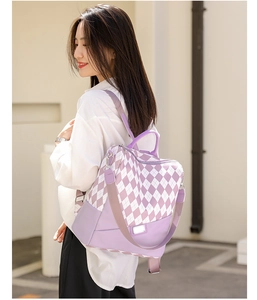 Side view of a purple and white diamond pattern backpack on a model in urban settings