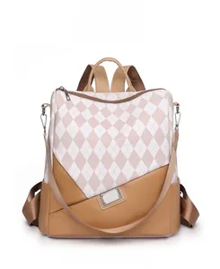 Front view of contrast color backpack featuring pink quilted pattern and brown leather bottom