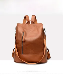 Front view of yellow-brown pebbled faux leather backpack with vertical zipper detail