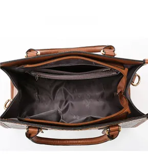 Internal view of brown pebble leather tote bag with zip pocket and gold hardware details