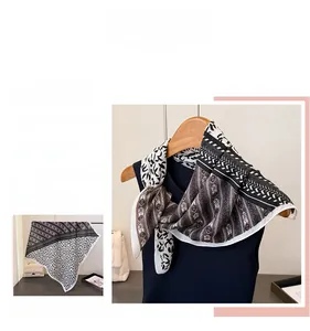 Detail of herringbone pattern cotton linen scarf with geometric floral print on hanger