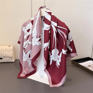 Floral print silk scarf in burgundy and pink draped over a mannequin for a luxury look