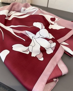 Detailed close-up of vintage floral print silk scarf with burgundy and pink iris pattern