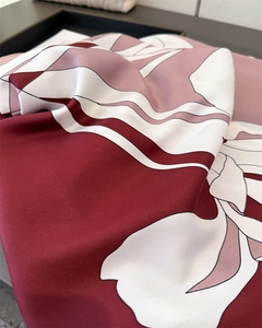 Detailed view of twill weave fabric and retro floral print on a luxury silk scarf