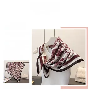 Detail of elegant scarf with burgundy vintage floral pattern and brown striped borders