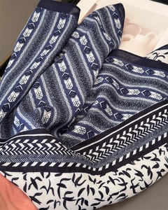 Detailed close-up of herringbone cotton-linen silk scarf with swallow pattern
