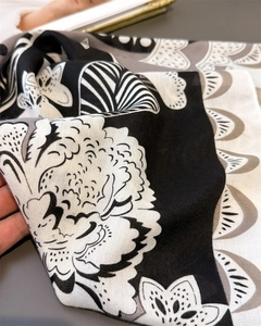 Détail de motif floral noir et blanc sur tissu doux en lin et coton pour écharpe