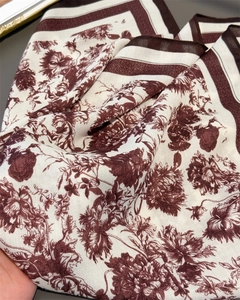 Close-up of floral herringbone pattern scarf with elegant toile de jouy style drape
