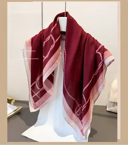 Detail of burgundy herringbone linen-feel scarf with white rope pattern on white mannequin