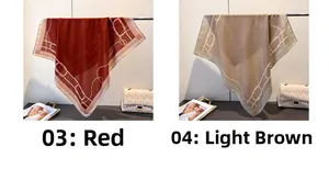 Detail view of red and light brown scarves with chain print on a minimalist hanger