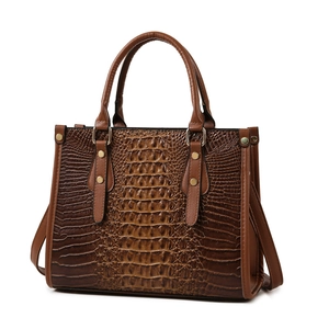 Brown crocodile embossed tote bag with dual handles and gold metallic hardware
