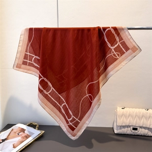 Detail of red-brown herringbone cotton linen scarf draped on a metal rack