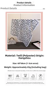 Detail view of monochrome polka dot scarf featuring herringbone texture and elegant drape