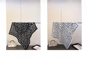 Detail of geometric polka dot square scarves in black and white silk-like fabric