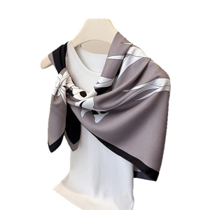 Silky satin square scarf with abstract grey floral print on a wooden hanger